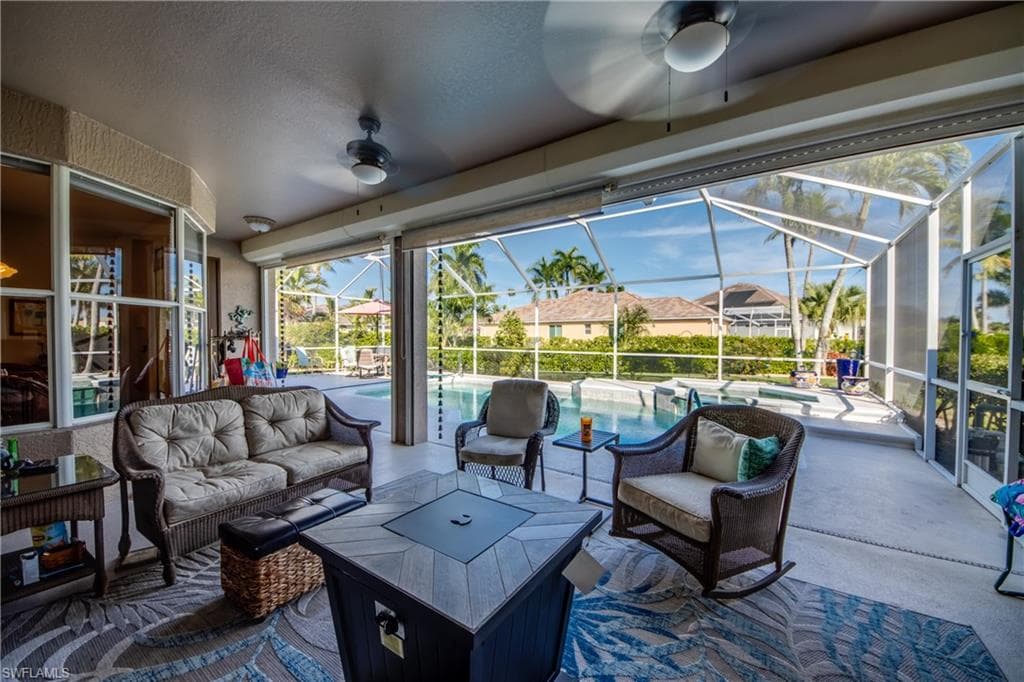 View of patio / terrace featuring an outdoor hangout area, ceiling fan, a sunroom, and a lanai