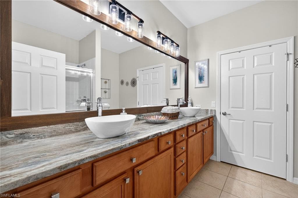 Primary ensuite bathroom with double vanity.