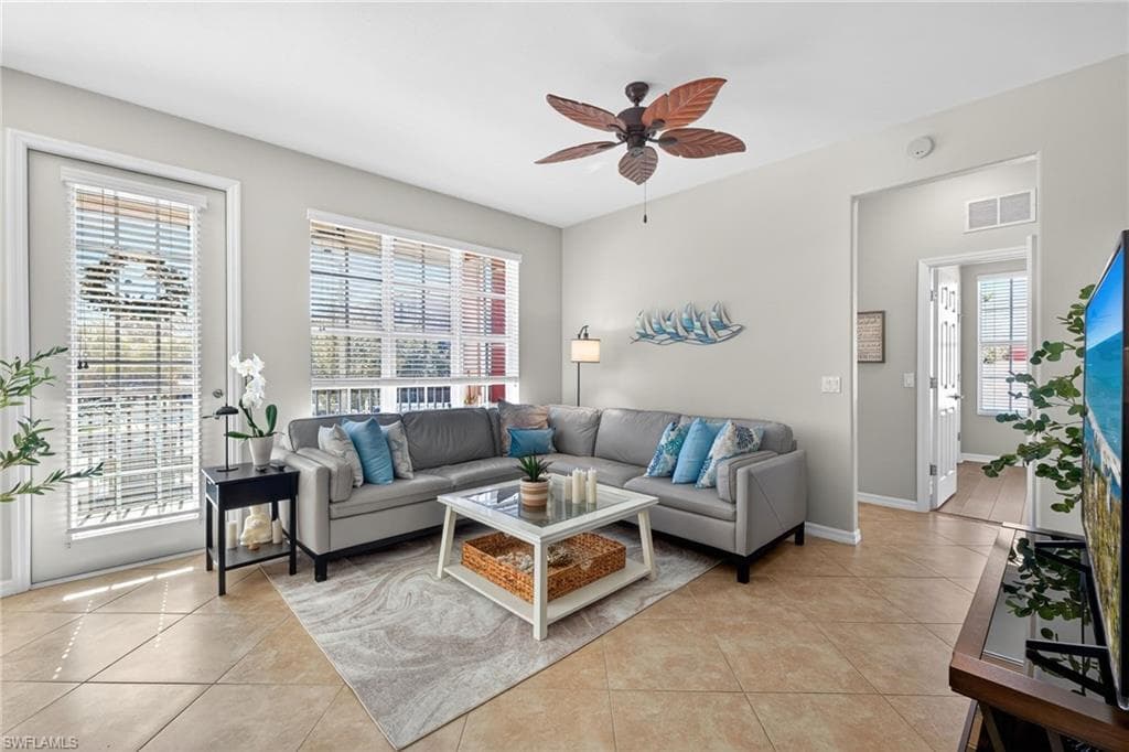 Spacious living room with natural light and access to screeend patio.