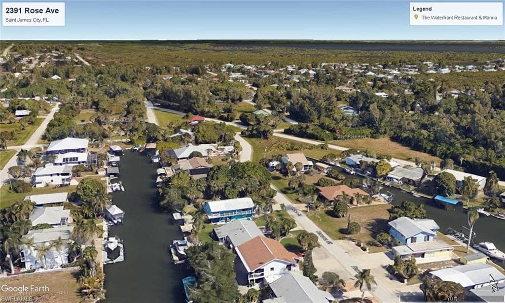 View of property location featuring nearby suburban area and a nearby body of water