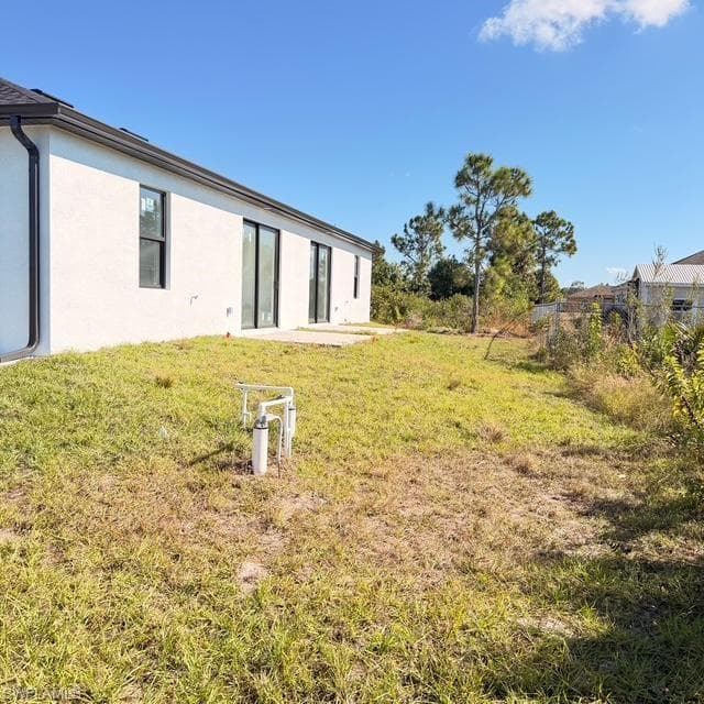 Rear view of property with a patio and stucco siding