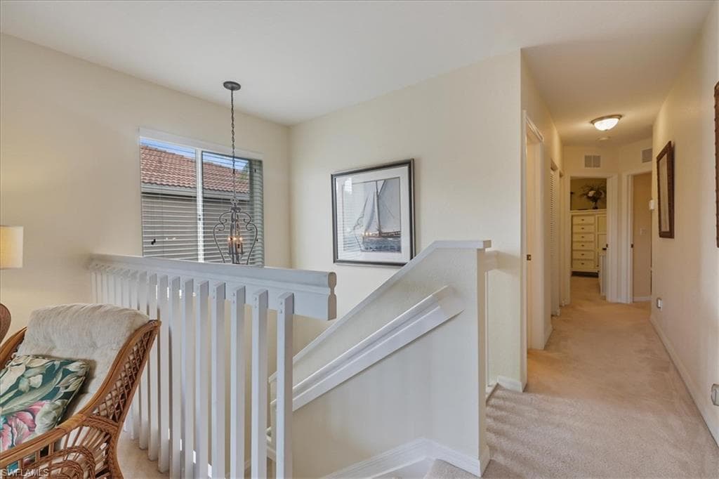 Living area featuring a ceiling fan and light colored carpet