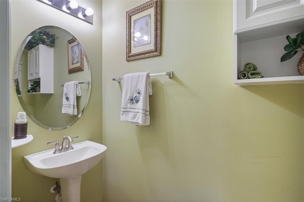 Kitchen with stainless steel appliances, arched walkways, wood finish cabinets, and light tile patterned floors
