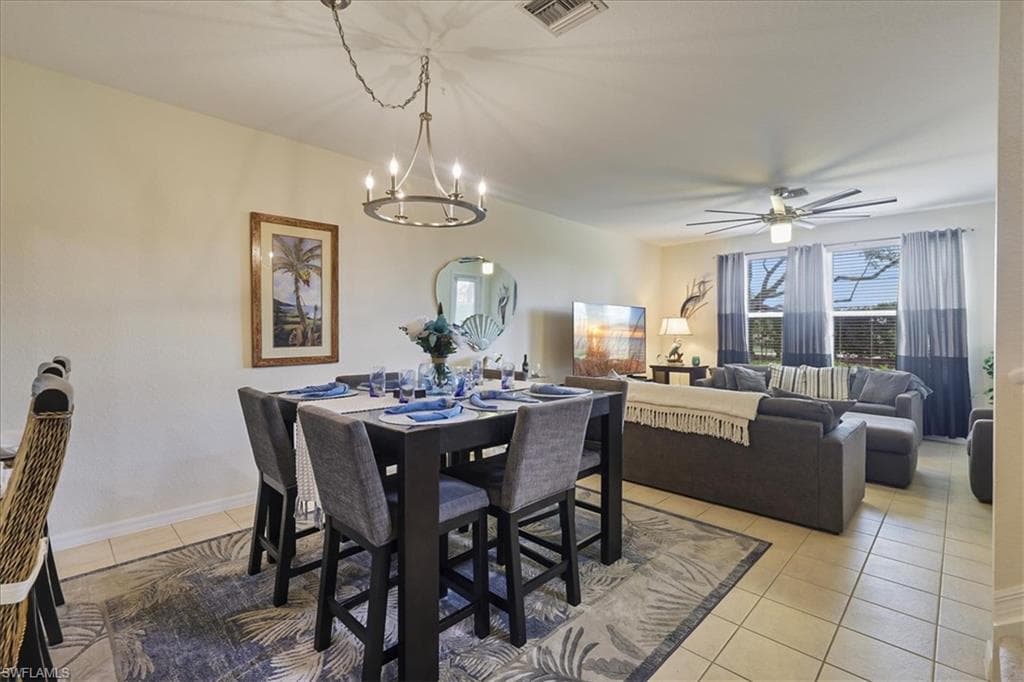 Living area featuring a ceiling fan and light tile patterned floors