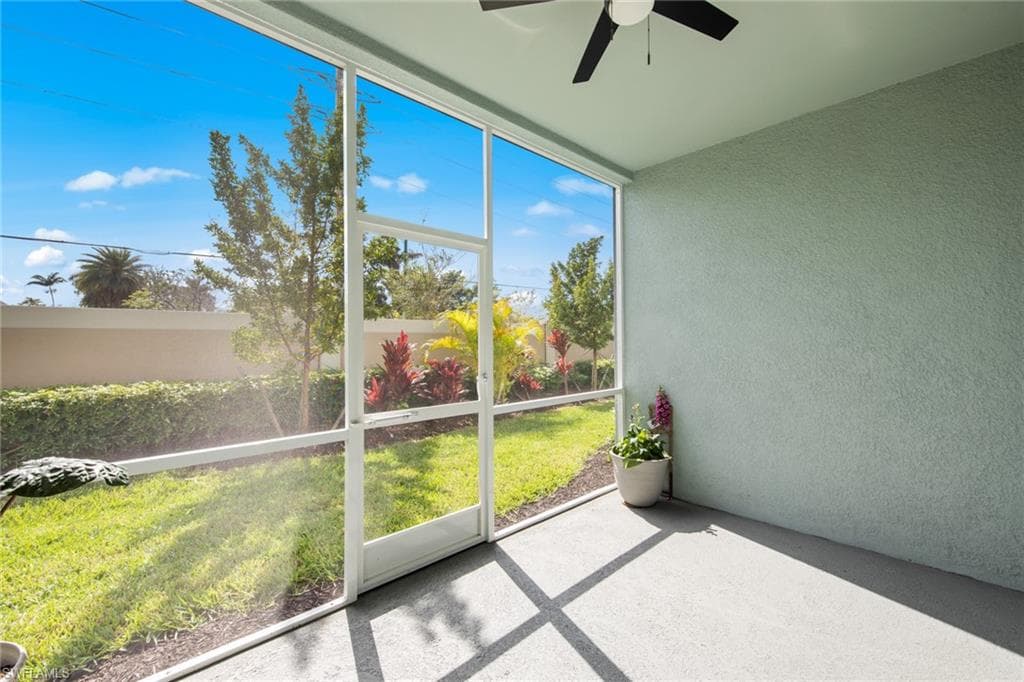 Unfurnished sunroom with ceiling fan