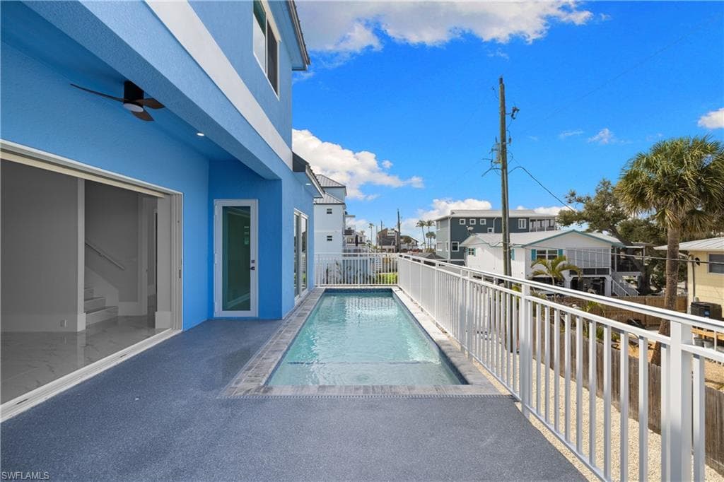 View of swimming pool featuring a residential view and a balcony