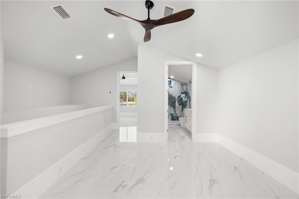Empty room featuring recessed lighting, ceiling fan, and light marble finish floors