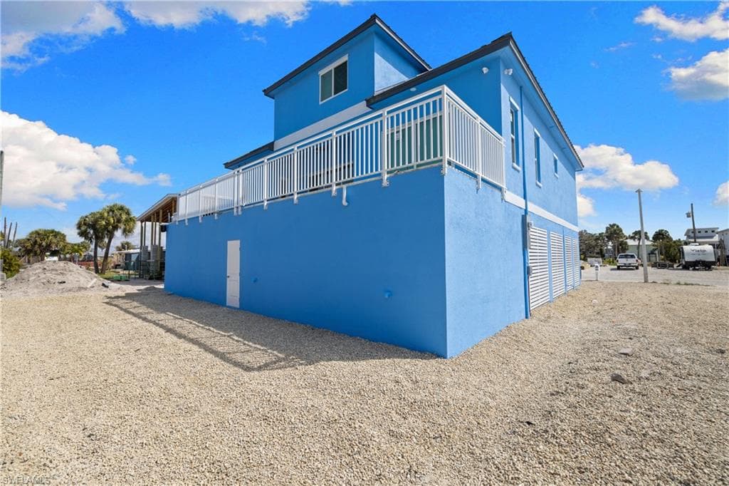 View of home's exterior with stucco siding and a wooden deck