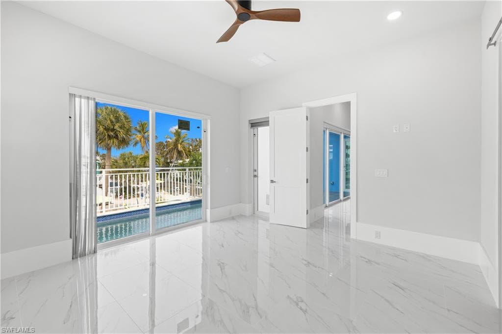Spare room with a ceiling fan, light marble finish flooring, and recessed lighting