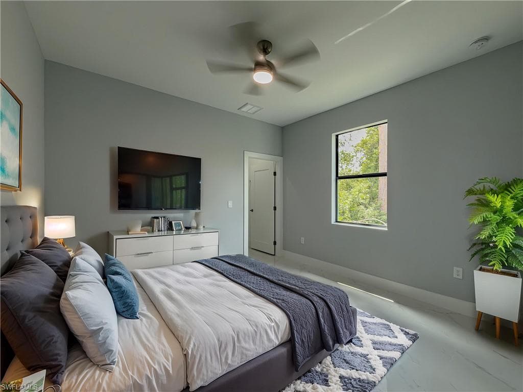 Bedroom featuring baseboards, ceiling fan, and visible vents
