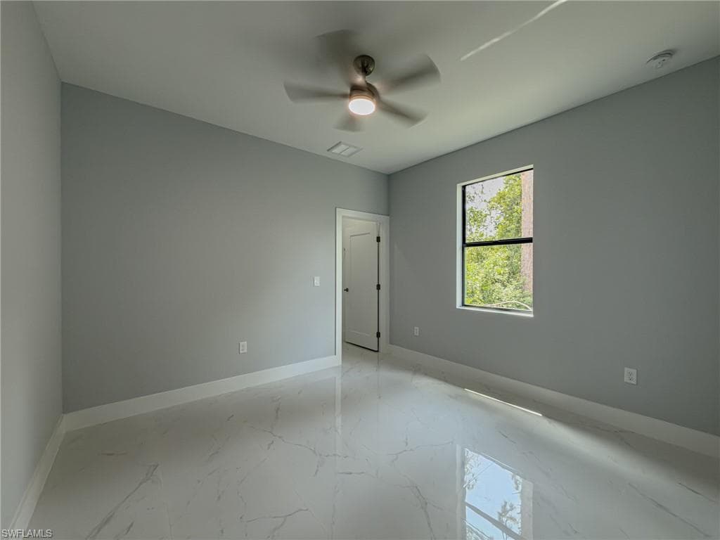Room #2 with baseboards, visible vents, ceiling fan, and marble finish floor