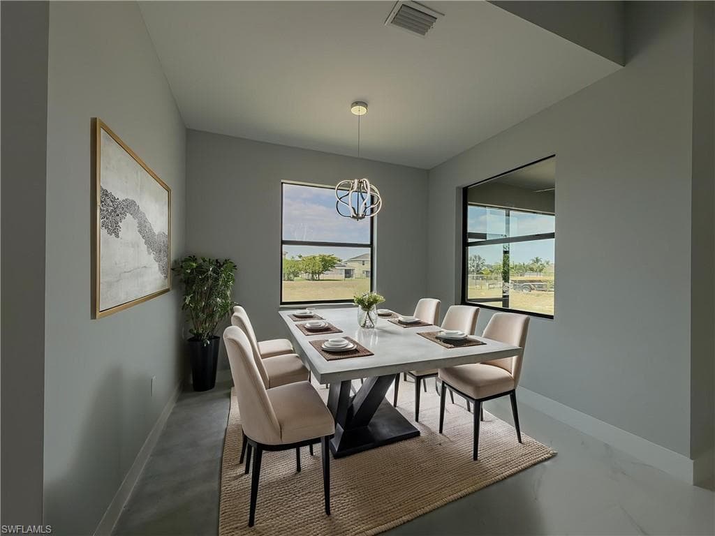 Dining space with a notable chandelier, baseboards, and visible vents