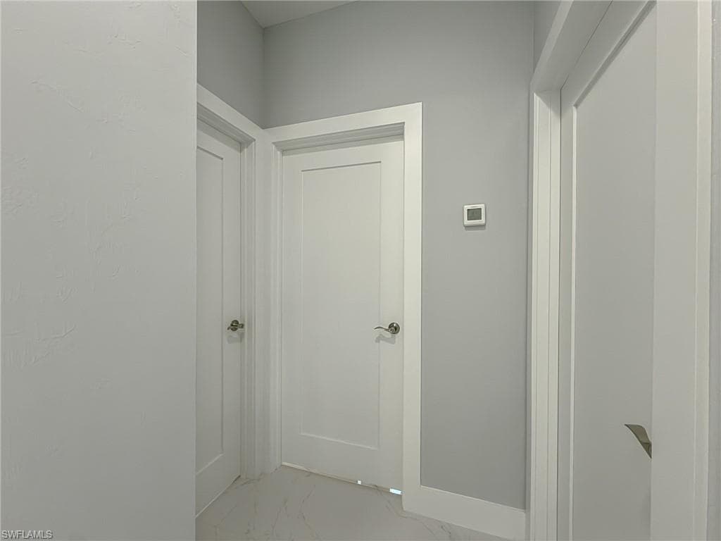 Hallway with marble finish floor