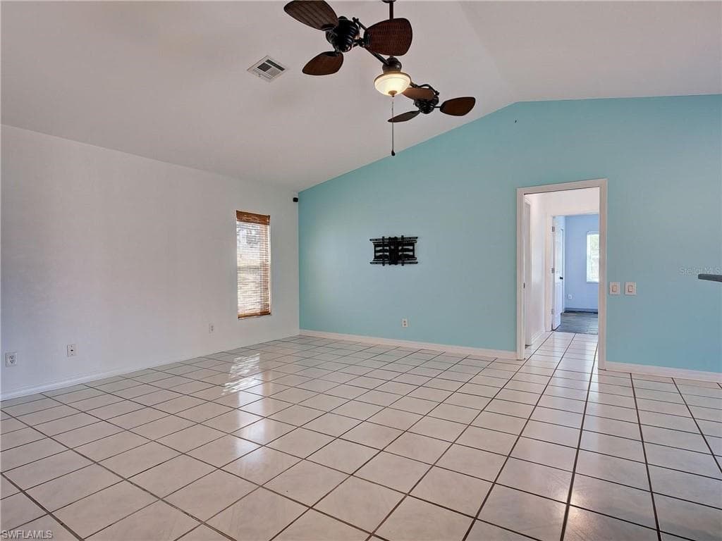 Spare room featuring ceiling fan and light tile patterned floors