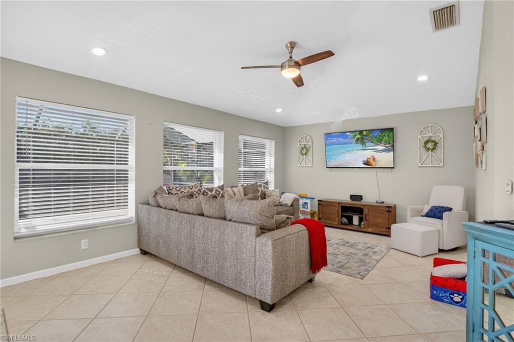 Living room featuring ceiling fan, light tile patterned floors, healthy amount of natural light, and recessed lighting