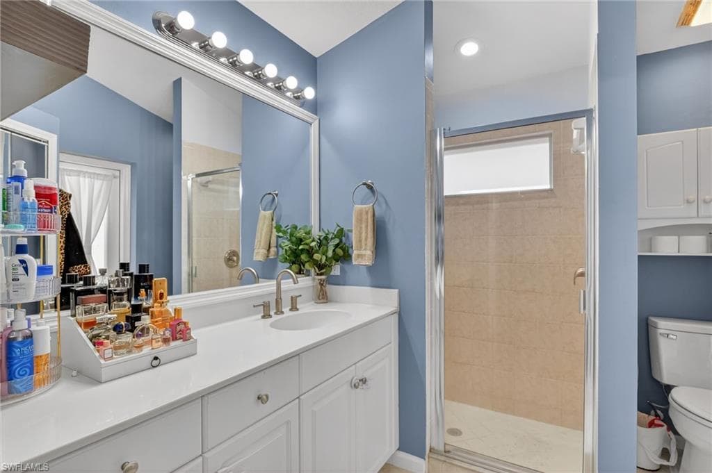 Full bath with a stall shower and vanity