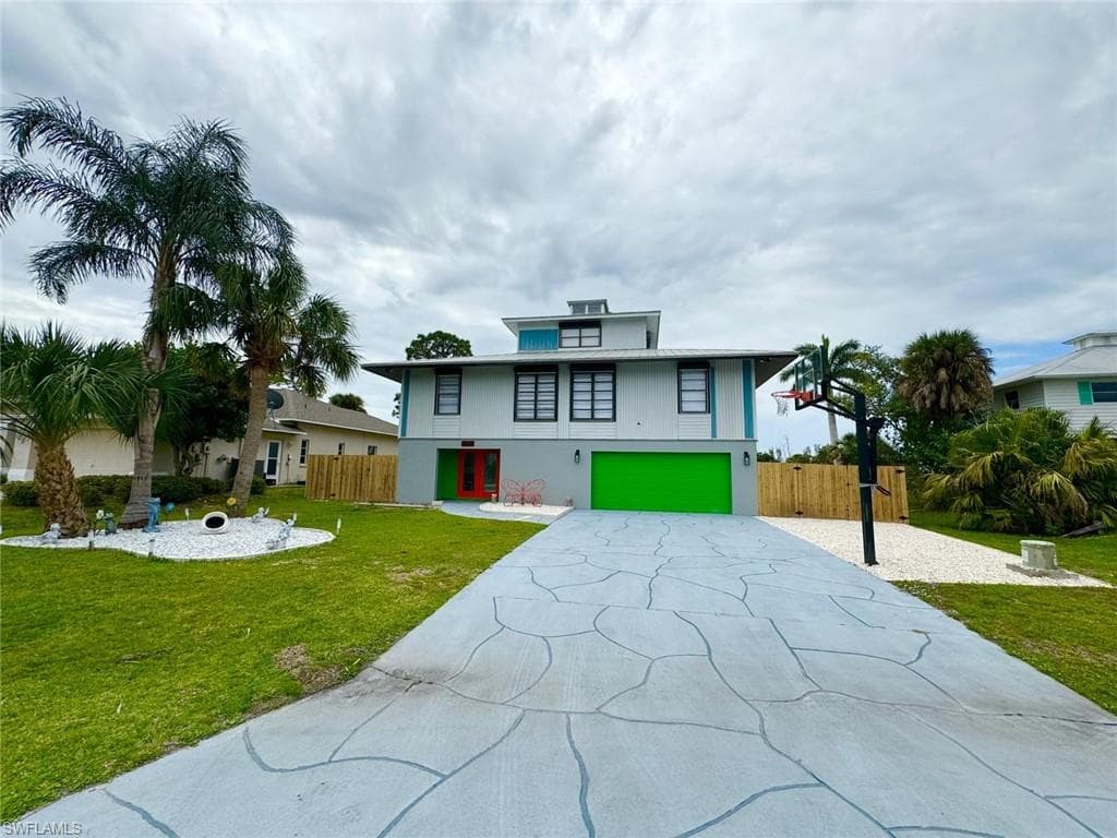 View of front of house featuring a garage, driveway, and stucco siding
