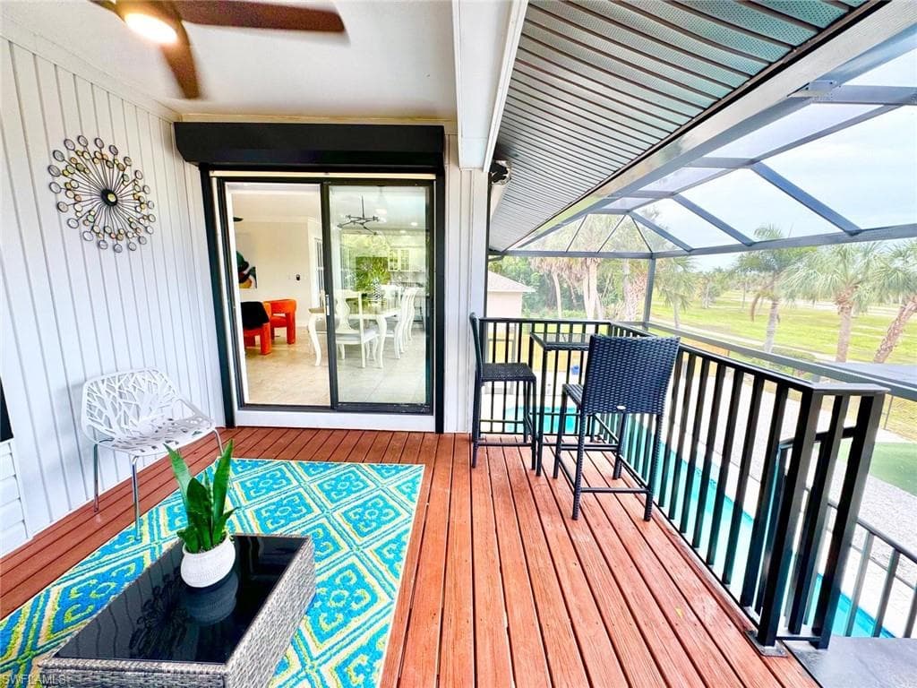 Wooden deck featuring a lanai and a sunroom