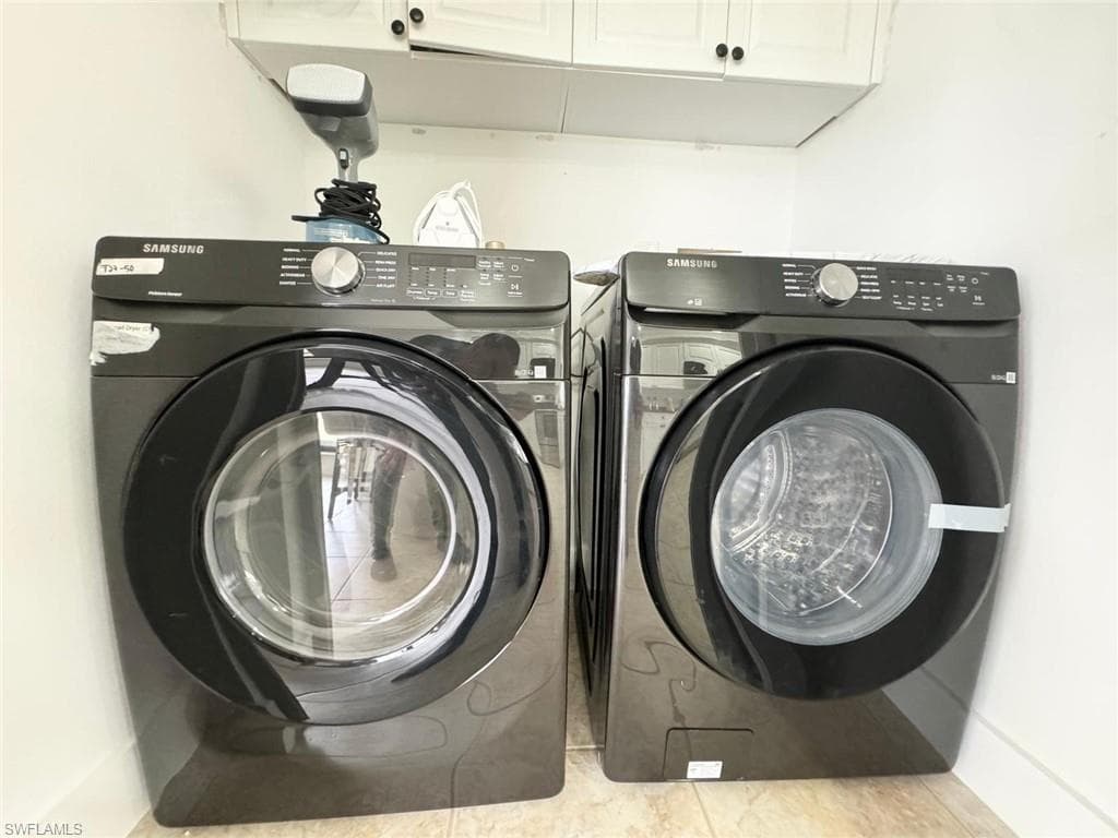 Laundry room featuring cabinet space and washing machine and dryer