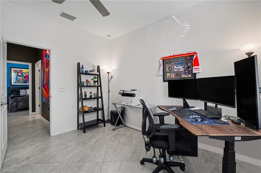 Office area with baseboards and a ceiling fan