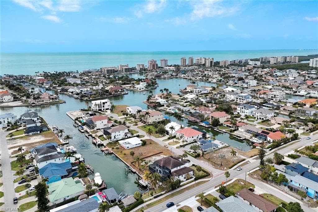 Aerial view of property and surrounding area with nearby suburban area