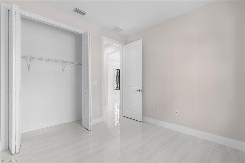 Unfurnished bedroom featuring baseboards and a closet