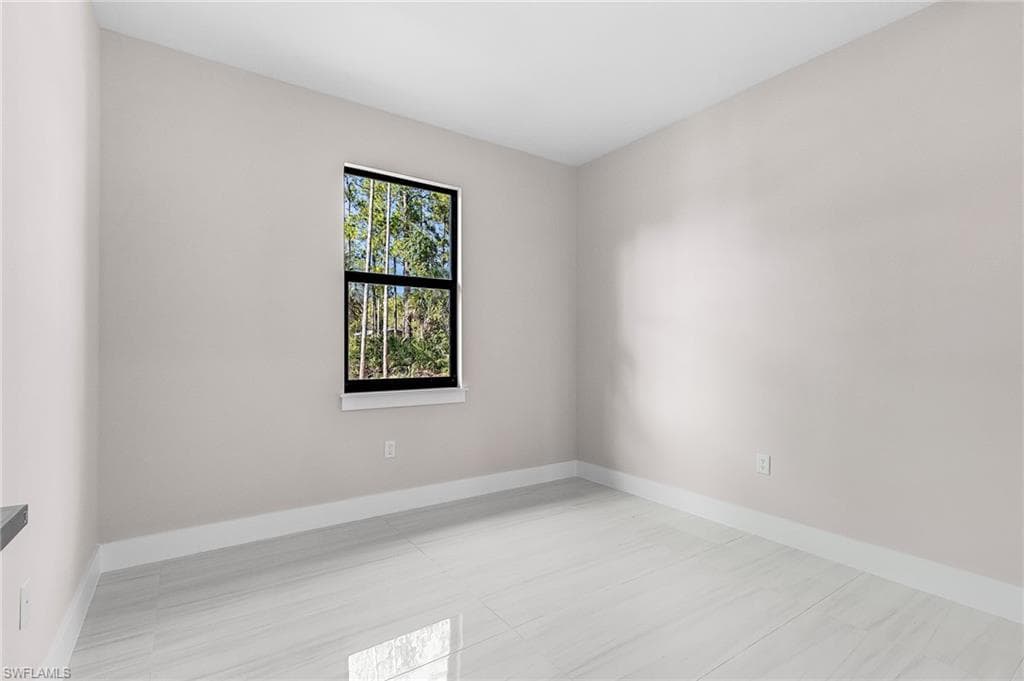 Empty room featuring baseboards