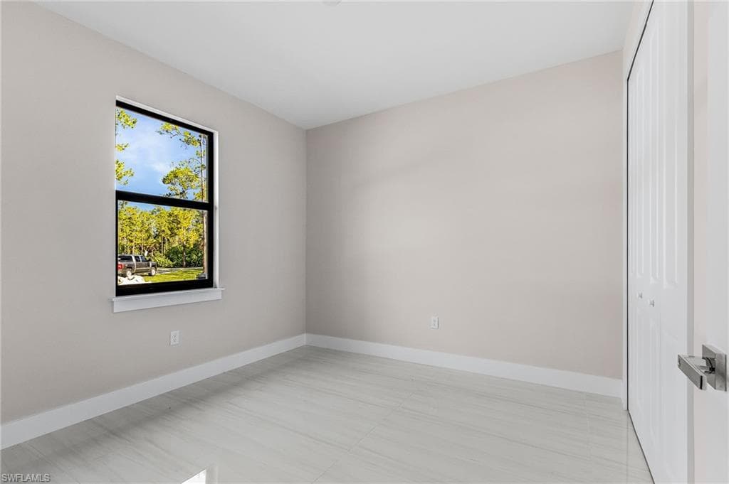 Unfurnished room with baseboards