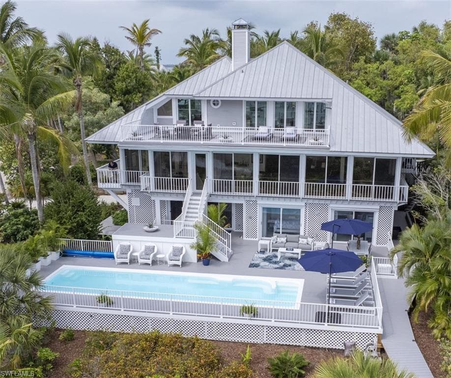 Back of house featuring a patio area, an outdoor pool