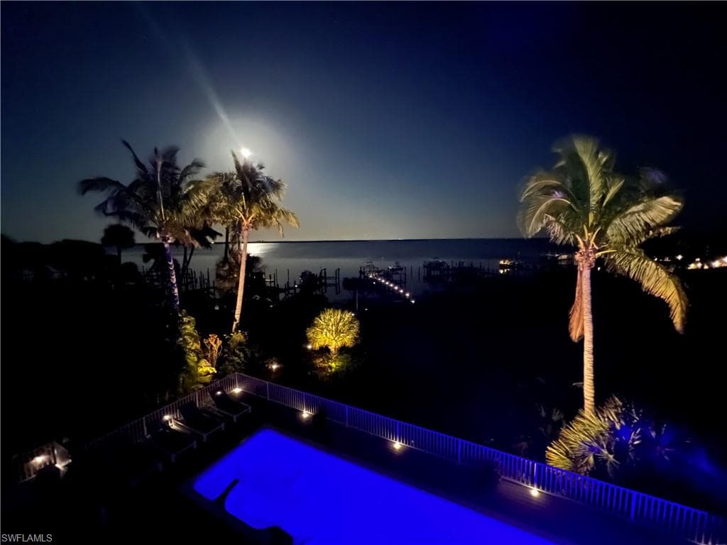 Pool at dusk with a water view