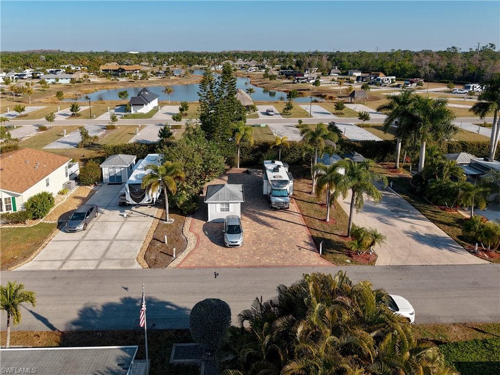 Aerial perspective of suburban area featuring a nearby body of water