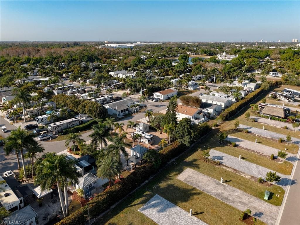 Aerial view of property and surrounding area featuring nearby suburban area