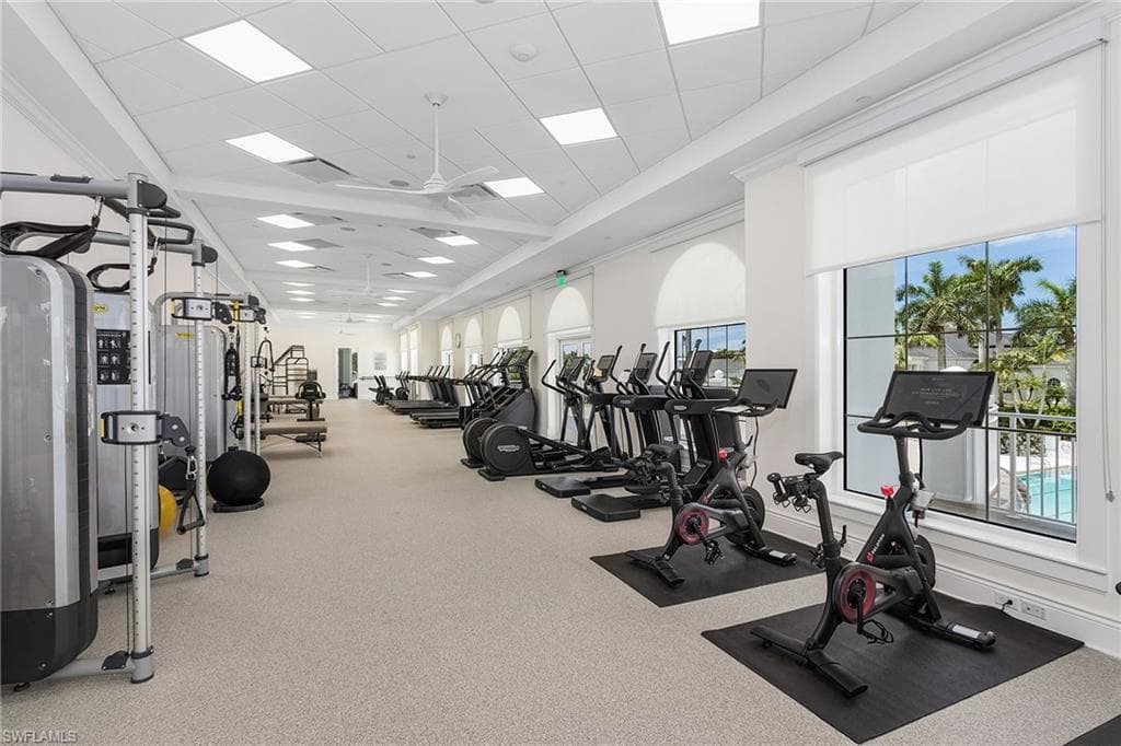 Exercise room featuring a drop ceiling and ceiling fan