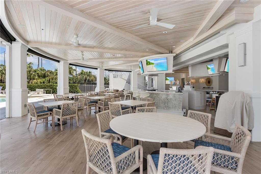 Dining area with ceiling fan, a wooden ceiling with exposed beams, and light wood-type flooring