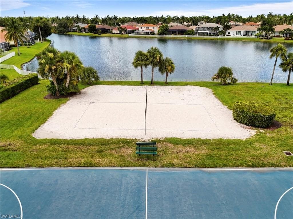 View of community featuring a residential view, volleyball court, and a water view