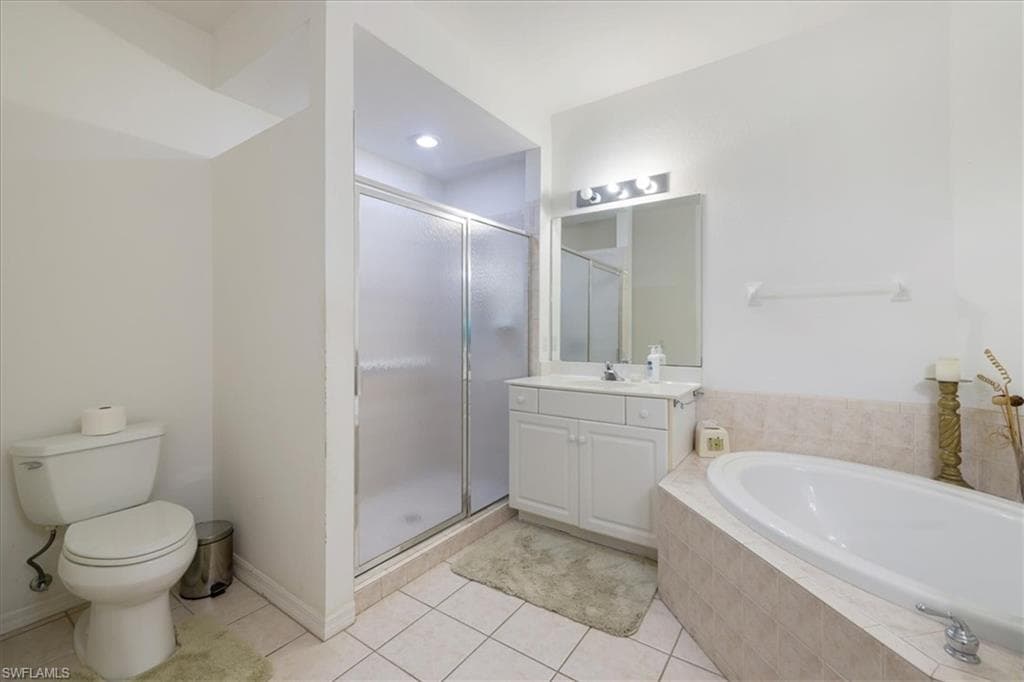 Bathroom with vanity, a stall shower, a bath, and light tile patterned floors