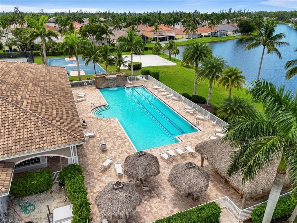 Community pool with a patio area and a residential view