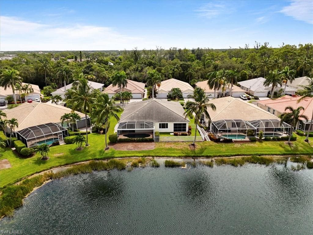Aerial perspective of suburban area featuring a nearby body of water
