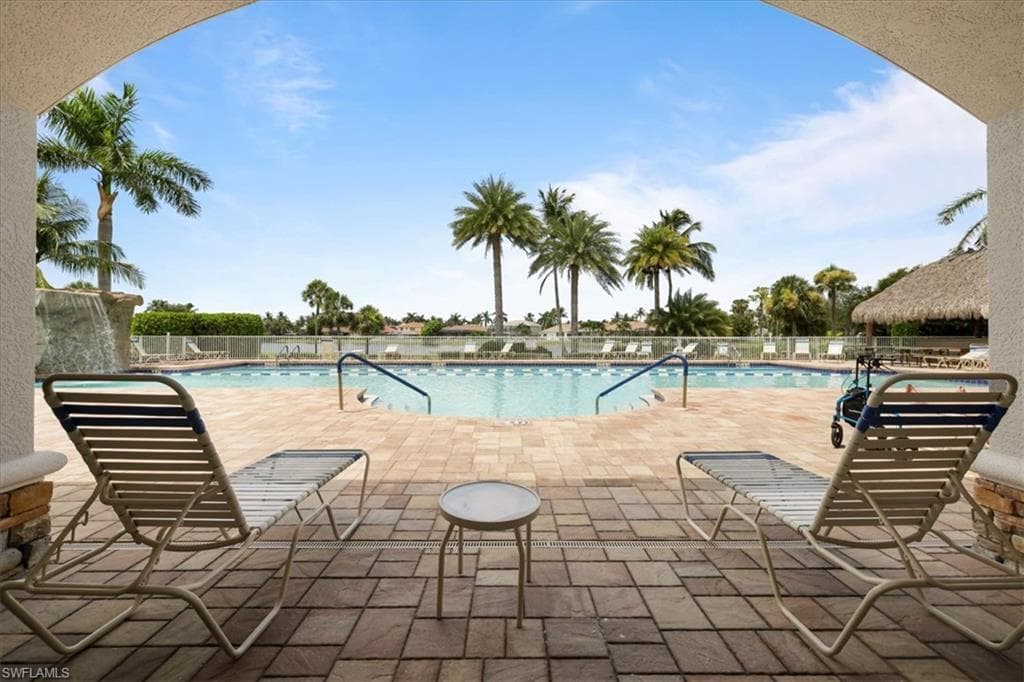 Community pool with a patio