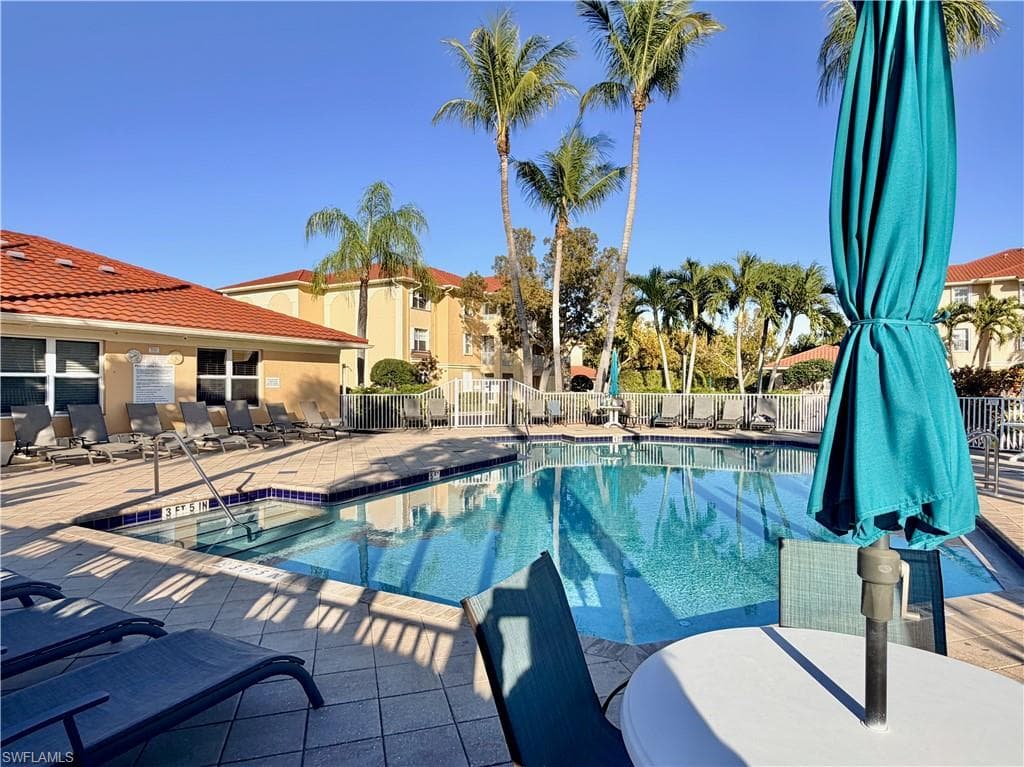 Community pool featuring a patio area and outdoor dining area