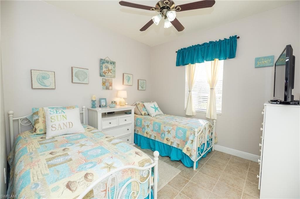 Bedroom featuring ceiling fan and light tile patterned flooring