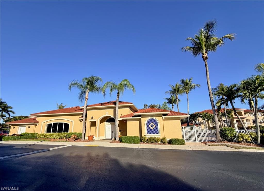 View of front of home featuring stucco siding and a tile roof