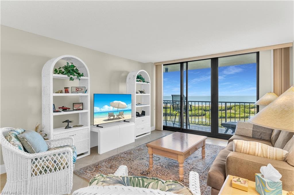 Living area with expansive windows and light tile patterned flooring