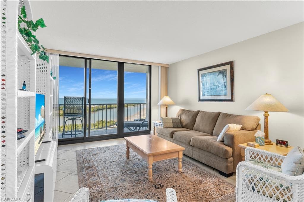 Living area with expansive windows and light tile patterned floors