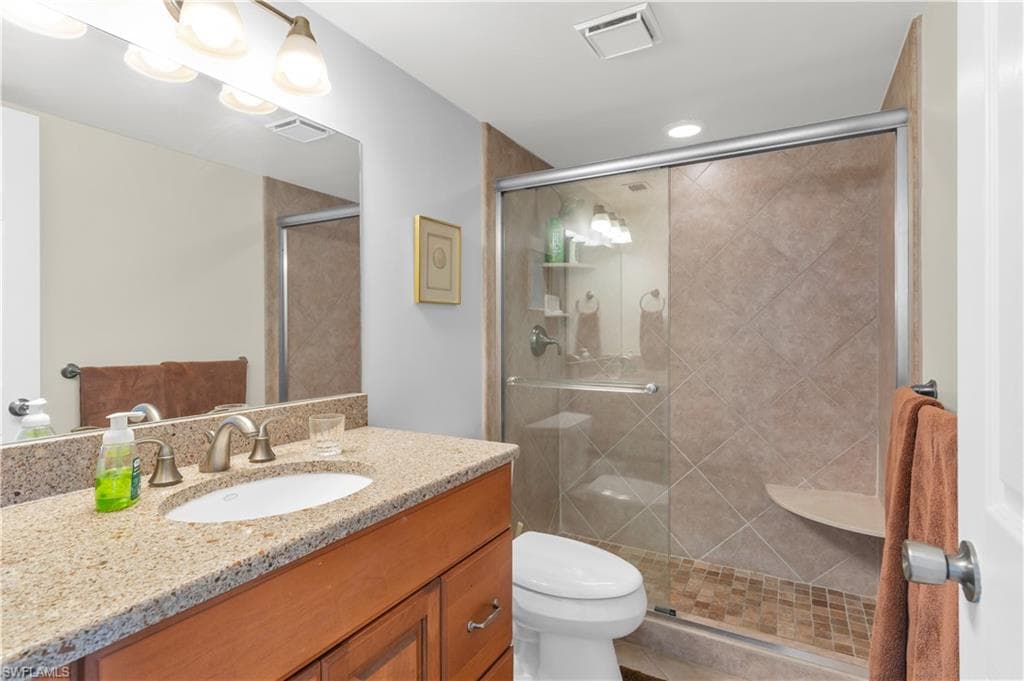 Full bathroom featuring vanity and a shower stall