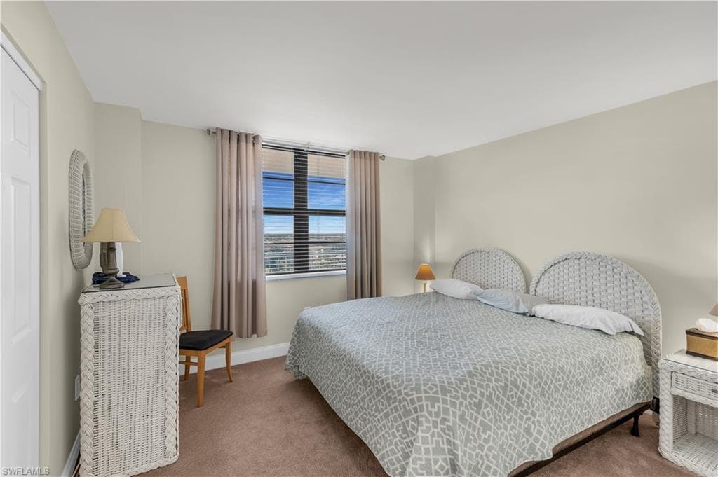 Bedroom featuring carpet flooring and baseboards
