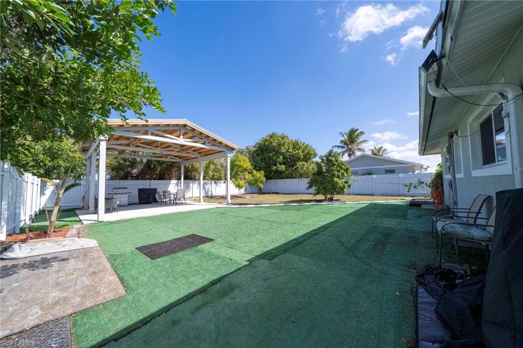 Fenced backyard with a patio area
