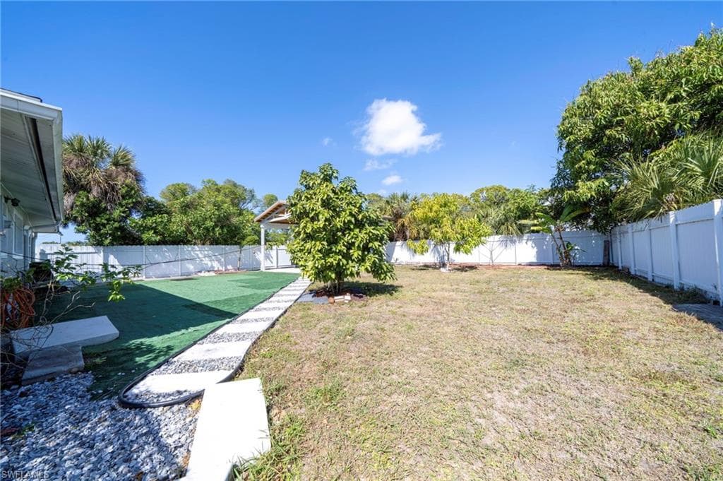 Fenced backyard with a patio area