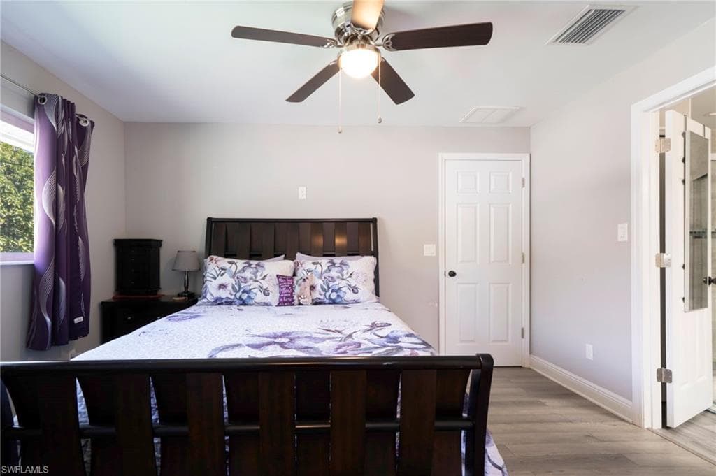 Bedroom with light wood-style flooring and ceiling fan