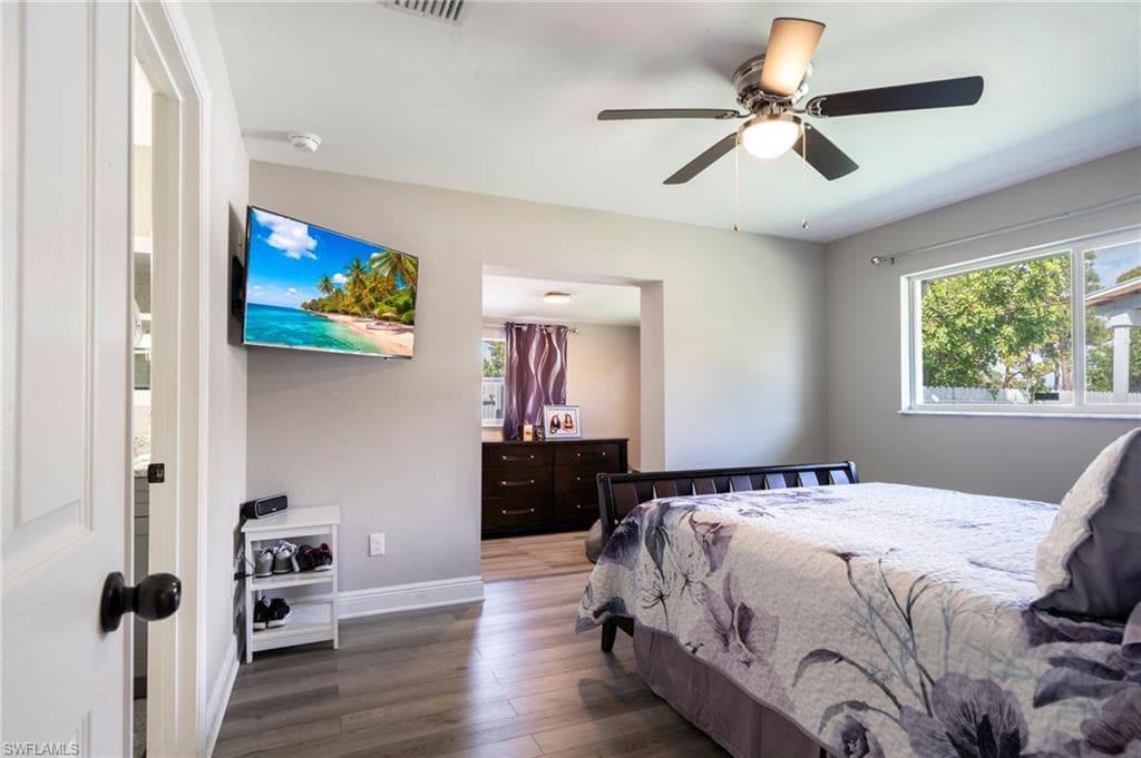 Bedroom featuring hardwood / wood-style floors and a ceiling fan